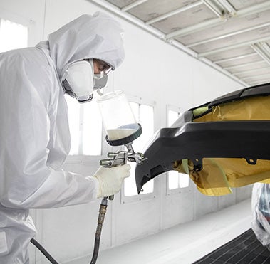 Collision Center Technician Painting a Vehicle | Vann York Collision Center in Hight Point NC